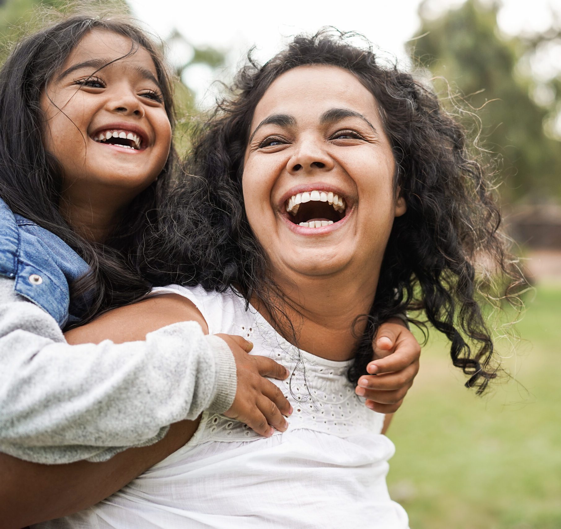 Happy indian mother having fun with her daughter.